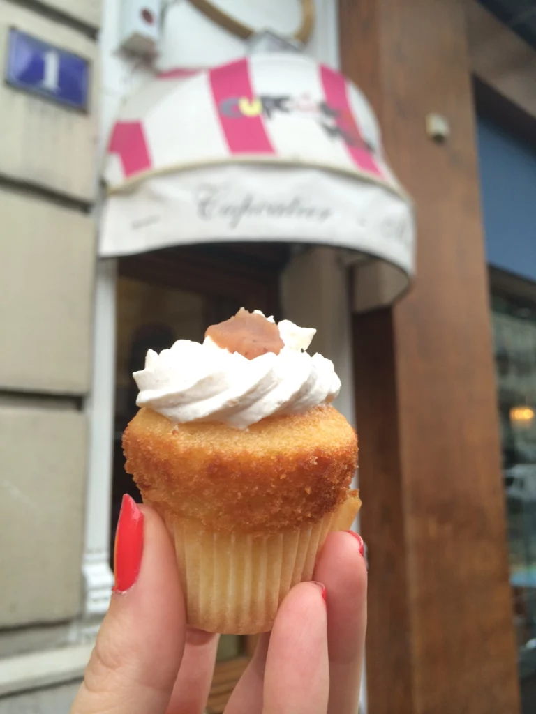 hand holding a small French cupcake